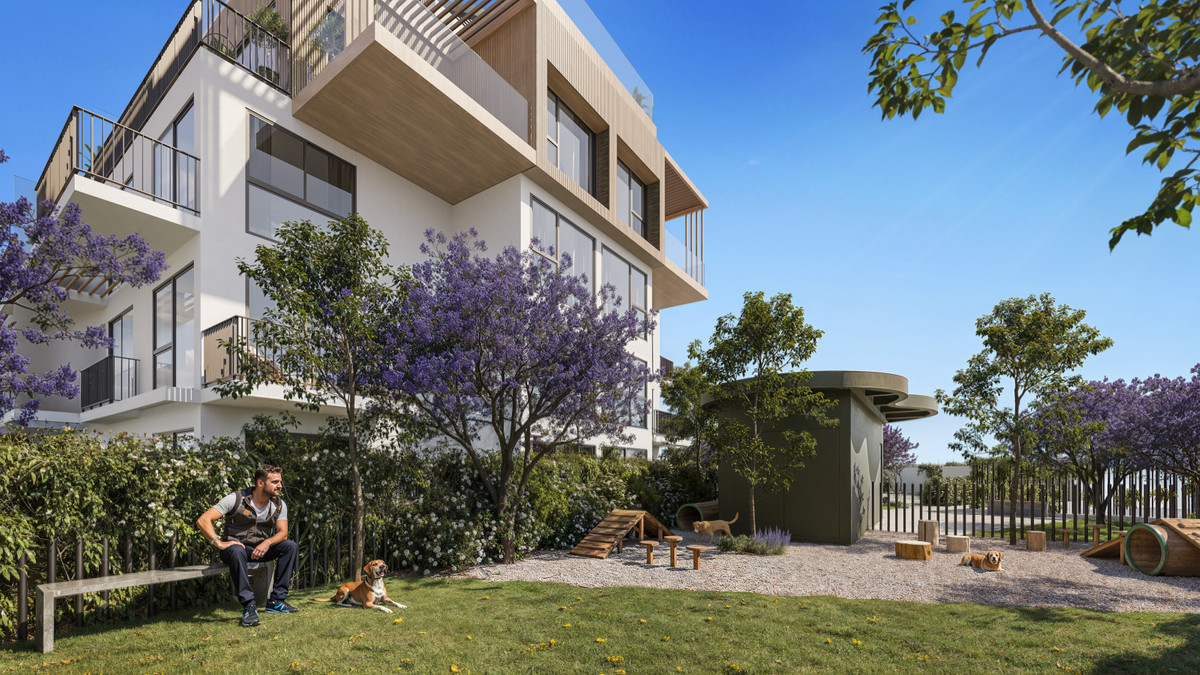 Ykines – Torremolinos - exterior garden and dog park area with jacaranda trees and modern residential building
